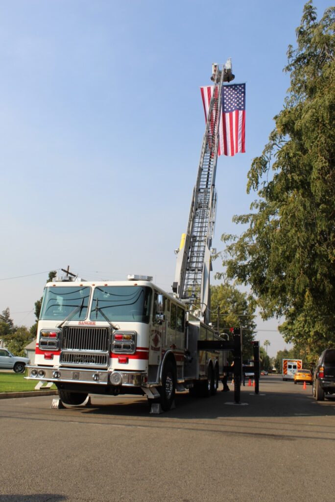 October 2020 Sanger FD brought a ladder truck with a garrison flag and several other vehicles